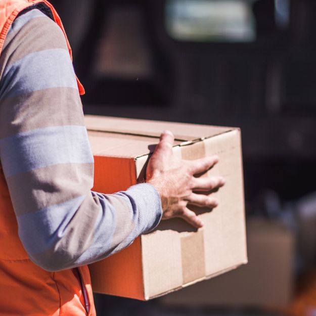 A person holding onto a box in his hand